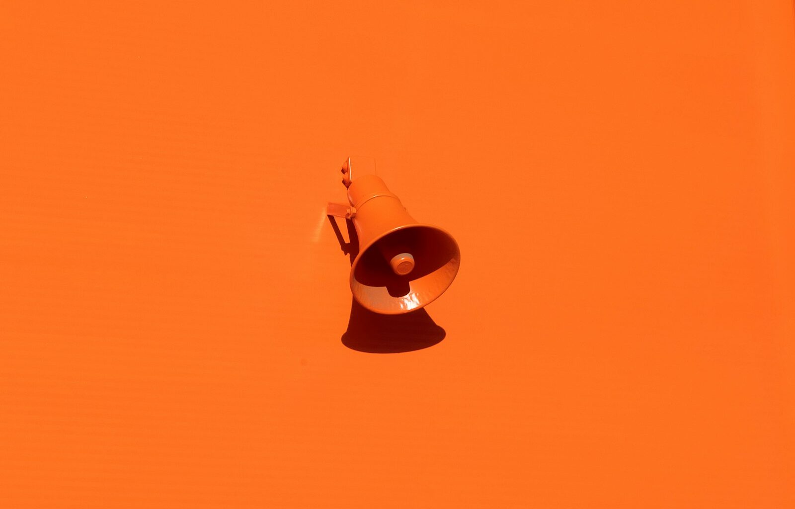 orange megaphone on orange wall