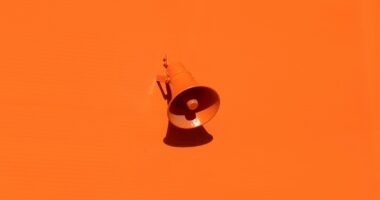orange megaphone on orange wall