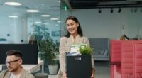 Woman carrying box of belongings leaving office
