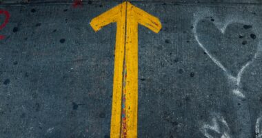 a yellow triangle on a road